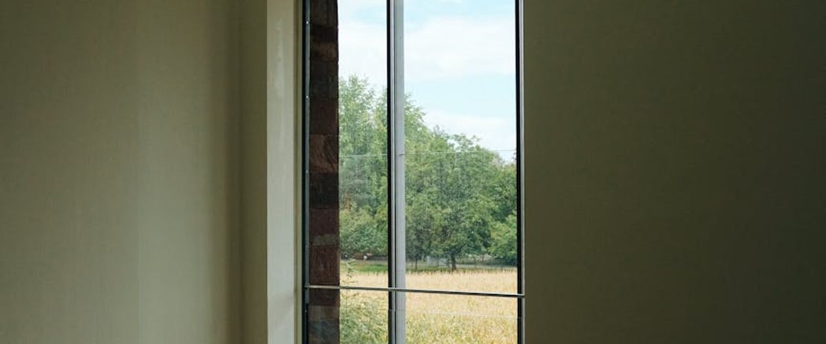 Panoramic view of a clean and peaceful yoga studio with natural light.